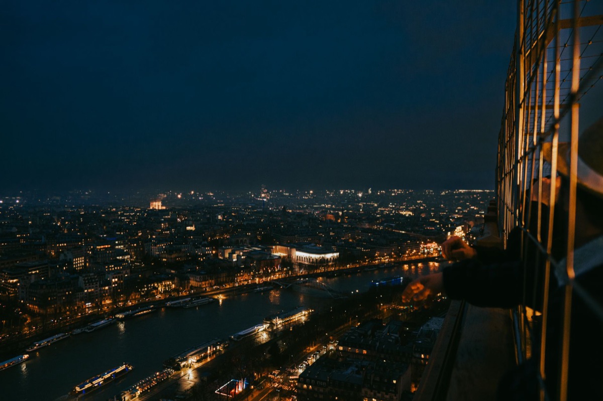 Eiffel tower at night against city skyline